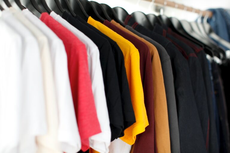 different colored t-shirts on a rack