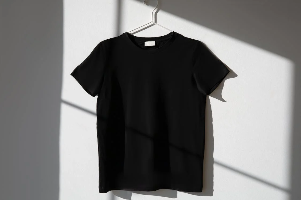 black t-shirt hung up on wall