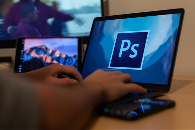 person using photoshop on their laptop