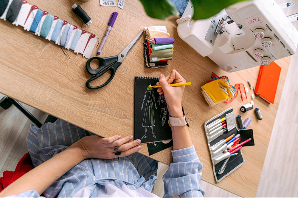 person at desk designing clothes